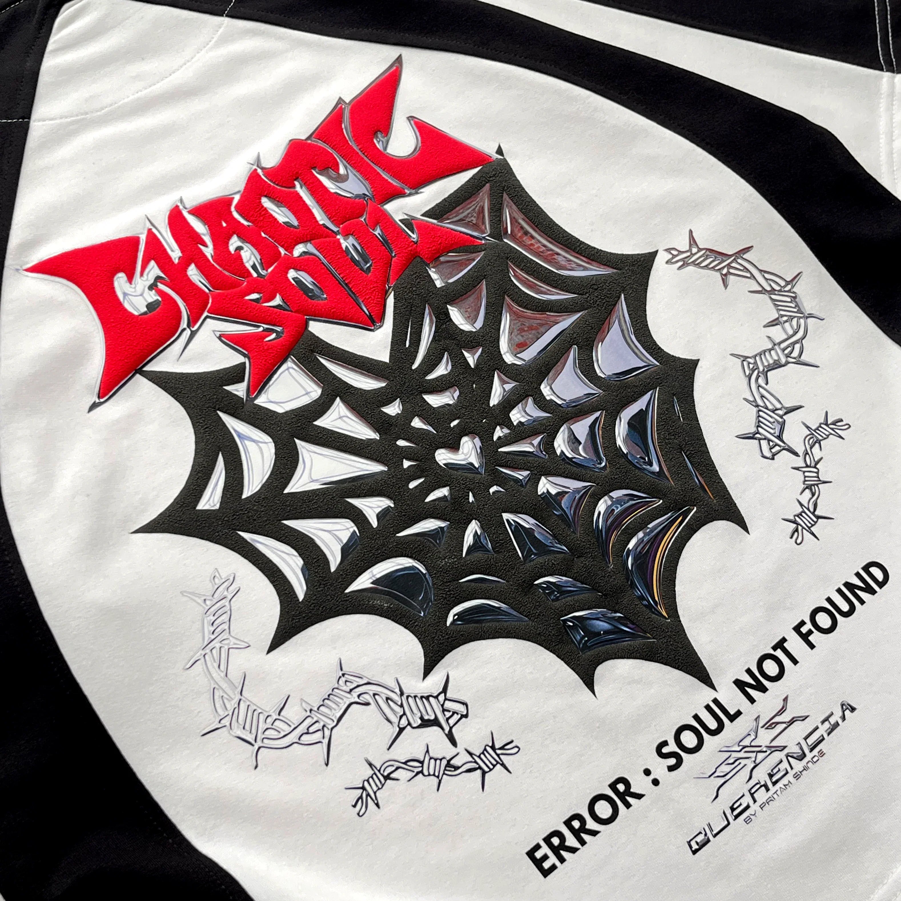 Close-up of the NOIR SOUL — FORM 03 graphic print, red spiked lettering over an intricate black spider-web design