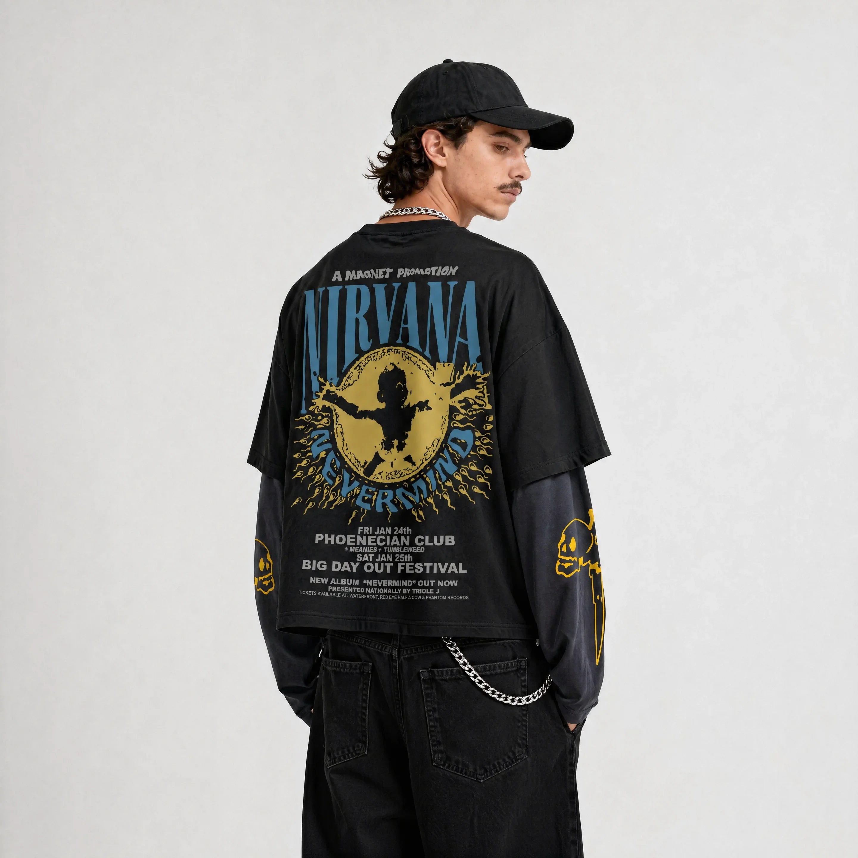 Model wearing Nirvana oversized t-shirt with black cap, black and grey streetwear outfit